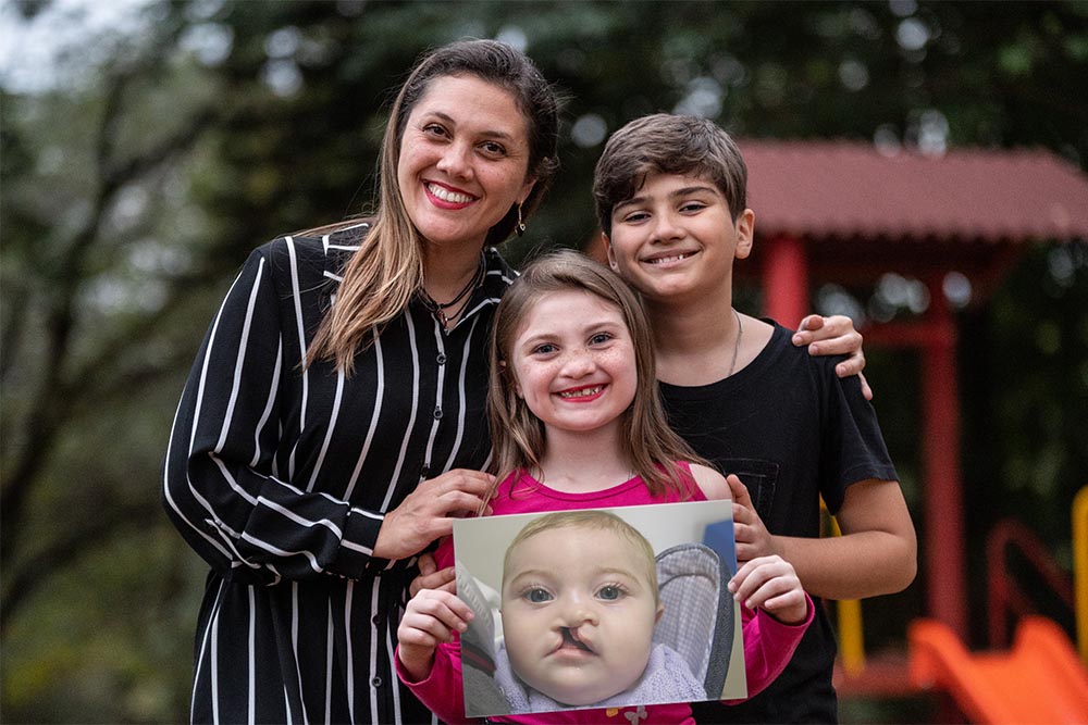 Grazi, Milena, and Nilo holding a picture of baby Milena