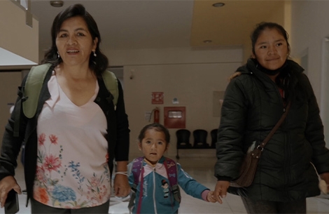 Elsa holding hands with a Smile Train patient and her mother at Fundación Ayninakuna in Sucre, Bolivia